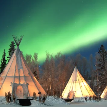 Aurora-Village-Yellowknife-Northwest-Territories-Canada-Aurora-Borealis-Northern-Lights-Winter-Three-Teepees-Landscape-Green-wonderland-Hero_0